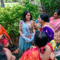 A high-angle shot showing the guest of honor surrounded by loving family. This perspective helps to tell the story of community and celebration.