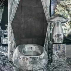 A shimmering silver chair and mirrored mushroom sculpture at 'The Melting Disco Ball'. Guests were greeted by a path of silver confetti, setting the stage for a night that defied the rules and celebrated the rebels.