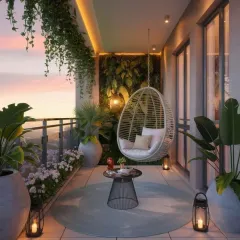 A beautifully lit balcony at sunset, featuring a comfortable wicker swing chair as the centerpiece. We used hidden LED lighting along the ceiling cove and lantern-style floor lamps to create a warm and dreamy atmosphere.