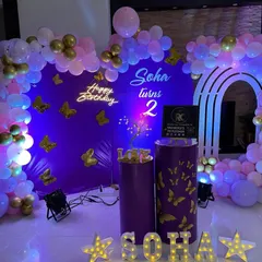 We love executing fun themes like this butterfly party for 'SOHA'. The purple backdrop is adorned with golden butterflies, which are also found on the plinths, tying the whole theme together with the balloon decor and personalized name.