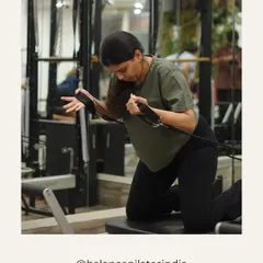 A moment of focus. This client is working her arms and back, building strength with the reformer's resistance.