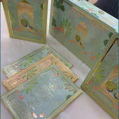 Our peacock-themed wedding invitation boxes, shown alongside the matching card inserts. The elegant design and premium materials make for a memorable first announcement.