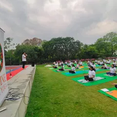 A wide shot of our International Yoga Day event, with our banner proudly displayed. We love creating these large-scale opportunities for the community to come together and practice in unity.
