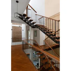 The new staircase in the Hyderabad home is a central feature connecting the floors. By replacing an older, bulkier staircase, we opened up the interior volume, creating a sense of spaciousness and improving the flow between living areas.