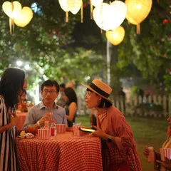 Guests enjoying the festive atmosphere at a themed event we catered for a renowned clothing brand. The outdoor setting was decorated with heart-shaped lanterns, creating a magical evening.