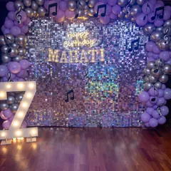 The complete look for Mahati's disco party. The shimmering sequin wall, marquee number, and musical note balloon arch created a stunning backdrop for the celebration.