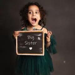 The pure excitement of a big sister-to-be. Her expression is priceless and adds so much joy to the family's maternity portraits.