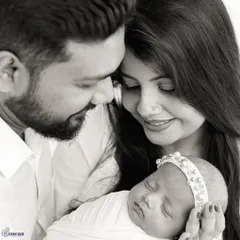 An intimate black and white close-up that captures the adoration of new parents. This style is perfect for conveying pure emotion.