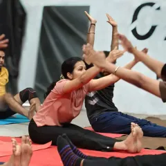 A seated forward bend, a classic stretch for improving hamstring and lower back flexibility. We do this together to stay motivated.