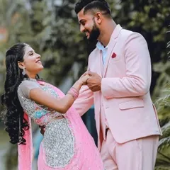 I love creating perfectly coordinated looks. Here, my client looks dapper in a custom pastel pink suit, perfectly complementing his partner's beautiful pink and silver lehenga. It's all about capturing your connection in style.