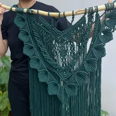 Here is a closer look at the 'Heer' tapestry, held up so you can see its full size and shape. The deep green color is so rich and looks amazing against a light-colored wall.