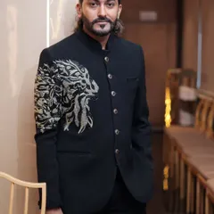 A confident pose in our black lion-embroidered Jodhpuri. This outfit is a popular rental choice for its unique design and sharp, modern cut.