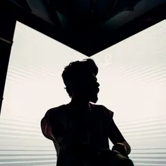A silhouette against a bright LED screen. A legacy comes with time, so you never stop working.