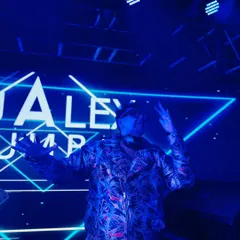 Killing the drip. Jacket on, vibe locked, ready to drop the hottest beats. The blue lighting sets the mood for a night of techno and house music.