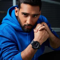 A powerful portrait from the Timex UFC campaign. The model is styled in a simple blue hoodie, with the intense lighting and his direct gaze creating a mood of strength and focus, letting the rugged watch stand out.