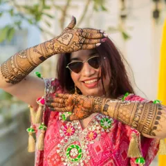 The best feeling is seeing a happy bride enjoying her mehendi. This shot captures the fun and excitement of a wedding celebration, with the intricate henna design being a central part of her look.