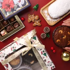 Our Christmas hampers are designed to bring holiday cheer. This one features a mix of our festive specials, including plum cake, stollen bread, and assorted chocolates, all beautifully packaged for gifting.