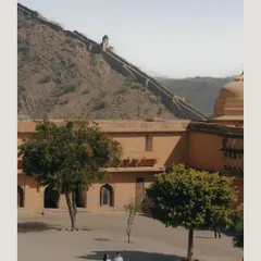 A wide shot capturing Vedika and Yuvraj against the grand scale of Amer Fort in Jaipur. This showcases how we use historical architecture to create epic and romantic pre-wedding imagery.