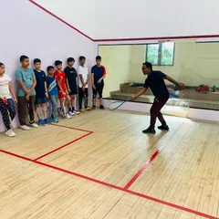 Our coaching philosophy is hands-on. Here, I am demonstrating proper swing mechanics to our junior players, ensuring they build a strong technical foundation from the very beginning of their squash journey.