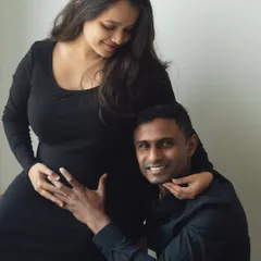 A sweet moment of connection with the baby. The dad-to-be listens closely to the bump, sharing a quiet moment with his partner and their little one on the way.
