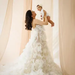 The same mother and child, sharing a moment of pure joy. Lifting her baby high, this mother's love and happiness are radiant, creating a powerful and emotive portrait.