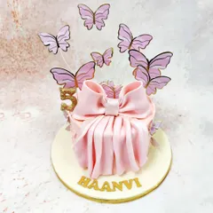Another view of the butterfly bow cake, highlighting the graceful pleats of the bow and the shimmering gold accents.