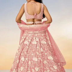 A back view of the pastel pink lehenga, highlighting the stylish blouse design.