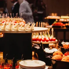A glimpse of our appetizer and dessert spread at a cocktail event. In the foreground, you can see individual dessert cups, part of a wider selection of sweet and savory bites.