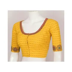 A simple, well-fitted blouse is a wardrobe essential. This yellow cotton blouse shows my commitment to classic designs, featuring a clean round neck and subtle embroidery on the sleeve cuffs for a timeless look.