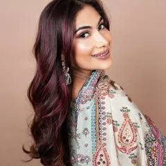 Stardust tangled in ruby waves. This portrait showcases the beautiful red tones against a traditional Indian outfit, proving that bold color can be incredibly elegant.