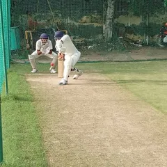 A young batsman leans into a forward drive, demonstrating excellent form and balance. Our batting drills are designed to develop a full range of scoring shots.