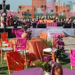 We believe in creating a whole vibe, not just a setup. This vibrant Mehendi decor combines a riot of colors, textures, and florals against a city skyline, setting the stage for a day of pure celebration.