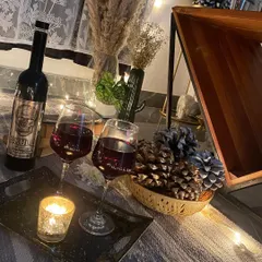 Another view of the rustic wine and candle arrangement, showing the warm and inviting textures of the decor.