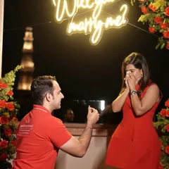 The moment of surprise and pure emotion is what I strive for. Here, against a backdrop of red roses and the iconic Qutub Minar, a beautiful new chapter begins.