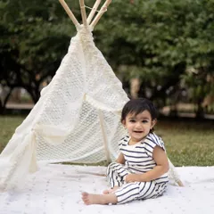 A happy smile from beside the teepee. Outdoor sessions allow kids to be themselves and explore.