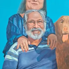 A detailed view of a family portrait, highlighting the father and the family dog. Capturing the distinct personalities of each family member, including pets, is essential to creating a successful group painting.