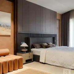 I love creating drama with texture and height. This bedroom features a floor-to-ceiling fluted wall panel behind a custom winged headboard. The combination of dark, moody tones and varied textures results in a sophisticated and cocooning atmosphere.