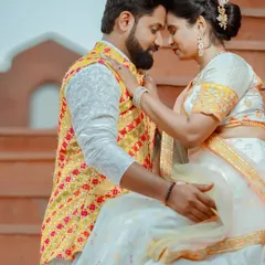 An intimate moment during a pre-wedding shoot. The couple is dressed in vibrant traditional attire, and the warm editing enhances the romantic mood.