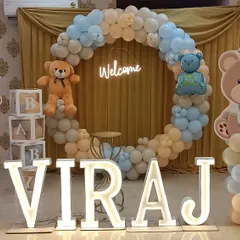 A full view of the welcome party setup for Viraj. I used a soft color palette of pastel blue, beige, and white, with multiple teddy bear cutouts and "BABY" blocks to complete the look.