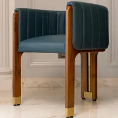 This artistic accent chair is a crown jewel for any living room. Made with a solid teakwood frame, deep blue leather upholstery, and brass-capped legs, it reflects a perfect synthesis of bold design and meticulous craftsmanship.