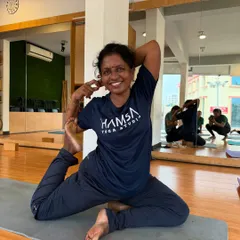 The smile of a practitioner in Eka Pada Rajakapotasana (Pigeon Pose) reflects the joy found in movement and self-expression.