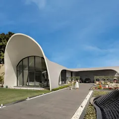 Architecture can be art. For this modern outhouse in Punjab, we designed a structure that emulates the graceful arc of a rising wave. This fluidic form creates a sculptural statement on the landscape, demonstrating our passion for pushing creative boundaries while delivering a functional, awe-inspiring space for entertainment and leisure.