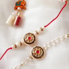 This is one of my favorite Bhai Bhabhi Rakhi sets. The traditional Kundan work on the bhai rakhi pairs perfectly with the delicate pearl Lumba for bhabhi. This set comes with Roli-Chawal to complete your Raksha Bandhan ceremony.