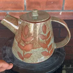 A student created this lovely stoneware teapot during her 15-day combined hand-building and wheel course. The leaf patterns were made using a wax resist technique before glazing.
