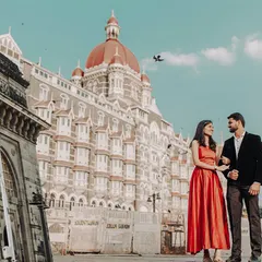 An elegant pre-wedding photo in front of the iconic Taj Mahal Palace Hotel in Mumbai, blending classic architecture with the couple's modern love story.