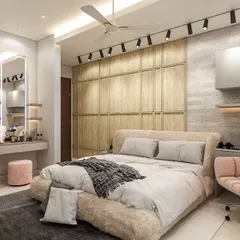 We designed this cozy bedroom to be highly functional. It features a full-wall wooden wardrobe, a floating study desk with overhead storage, and a dedicated dressing table next to the bed.