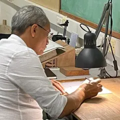 At the drafting table, where ideas first take shape. The act of drawing by hand is fundamental to my practice, a direct connection between thought and form.