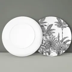 The same tropical foliage pattern applied to the back of a decorative plate. Even in simple black and white, the intricate details of the leaves create a stunning visual impact.
