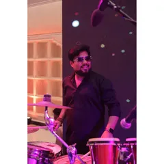 The man behind the beats. Our percussionist adds layers of rhythm to our music, from subtle grooves to powerful drum solos that get everyone moving.