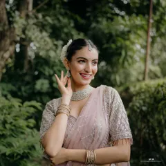 A close-up bridal portrait filled with joy. The bride's radiant smile and delicate jewelry are the focus of this beautiful shot.